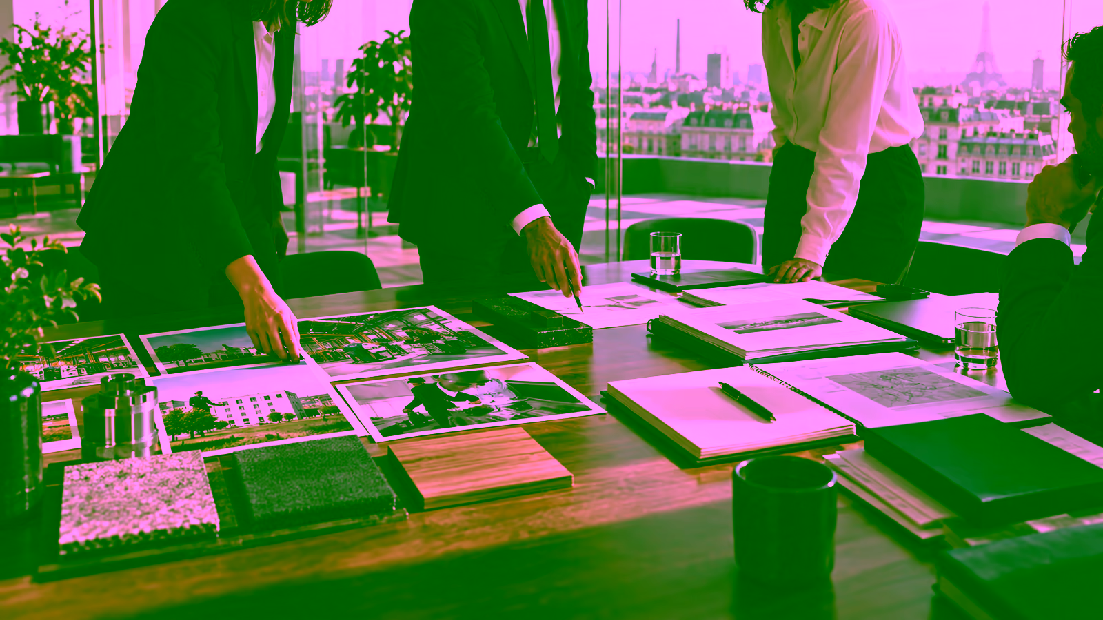An investment team jointly reviews industrial assets and private-fund materials.